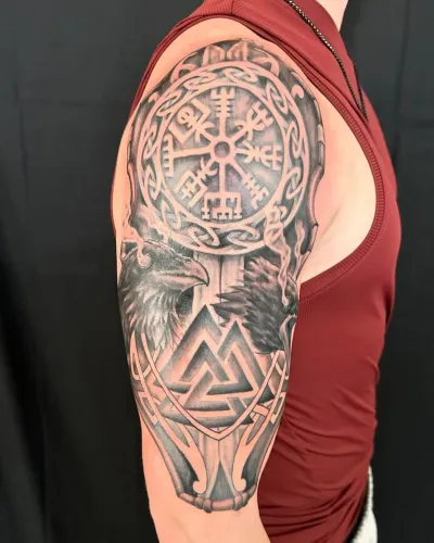 Black and grey Norse half sleeve with a Vegvisir compass, valknut and raven — by Adam Crane at Ministry Ink