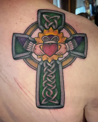 Colour Celtic cross with a Claddagh heart and hands on a shoulder — by Adam Crane at Ministry Ink