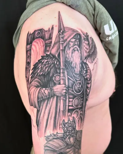 Black and grey armoured knight holding a spear on an upper arm — by Adam Crane at Ministry Ink