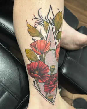 Neo-traditional red poppies with a diamond outline on a forearm — by Adam Crane
