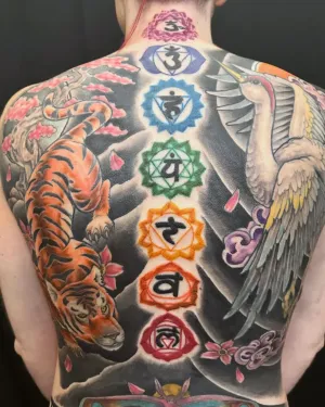 Full colour back piece with chakra symbols, a tiger, a crane and cherry blossom — by Adam Crane