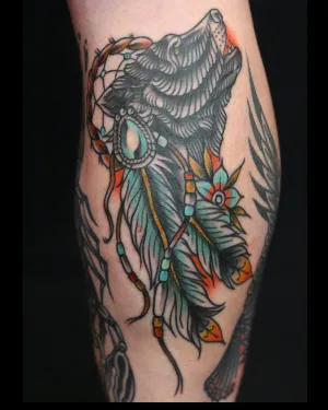 American traditional wolf head with feathers and beadwork on a calf — by Chay Menke