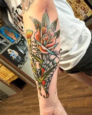 American traditional torch and foliage forearm piece in colour — by Chay Menke