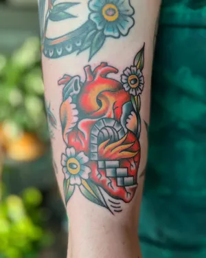 American traditional anatomical heart with flowers on an upper arm — by Chay Menke