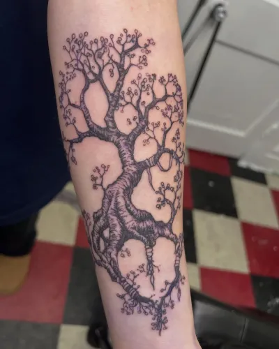 Fine line blossoming tree with delicate branches on a forearm — by Gabriel Gonzalez at Ministry Ink