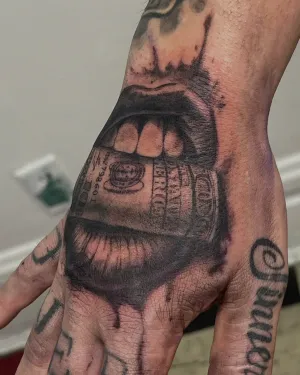 Black and grey money-mouth portrait tattooed on a hand — by Gabriel Gonzalez