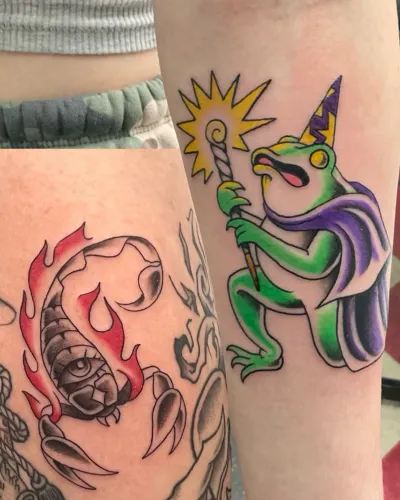 Colour traditional frog and flames on a lower leg — by Gabriel Gonzalez at Ministry Ink